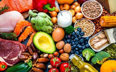 Colorful assortment of fresh and healthy food items including fruits vegetables meat fish dairy nuts and grains