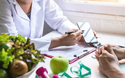 Doctor consulting a patient about nutritional health using a smartphone and medical report, with fruits and vegetables on the table.