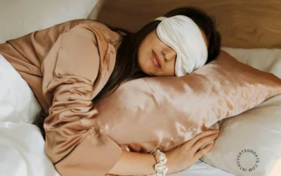 10 Better Evening Routine for Good Sleep A woman sleeping peacefully on a silk pillow while wearing a sleep mask and satin sleepwear