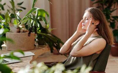 Methods based on science to change mental focus Woman practicing mindfulness meditation at a desk surrounded by green indoor plants