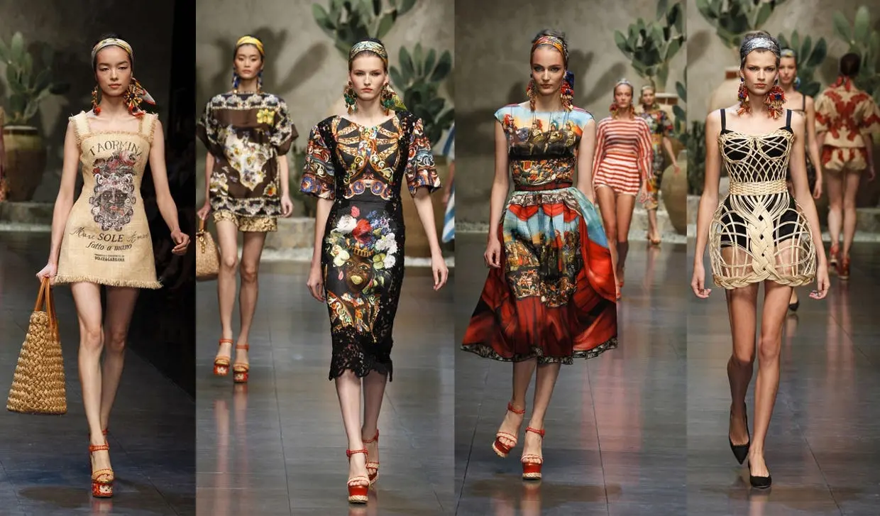 Models walking down the runway showcasing vibrant, culturally-inspired designer dresses
