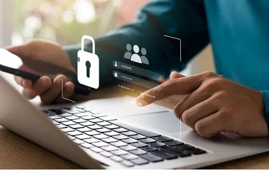 Ways to keep your personal information secure online Person securing login credentials on laptop with smartphone — concept of online data protection and cybersecurity.