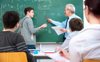 Teacher explaining physics equations to students in classroom