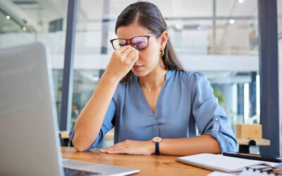How to Deal with Emotional Burnout at Work: A Complete Guide Woman experiencing emotional burnout at work while sitting at her desk