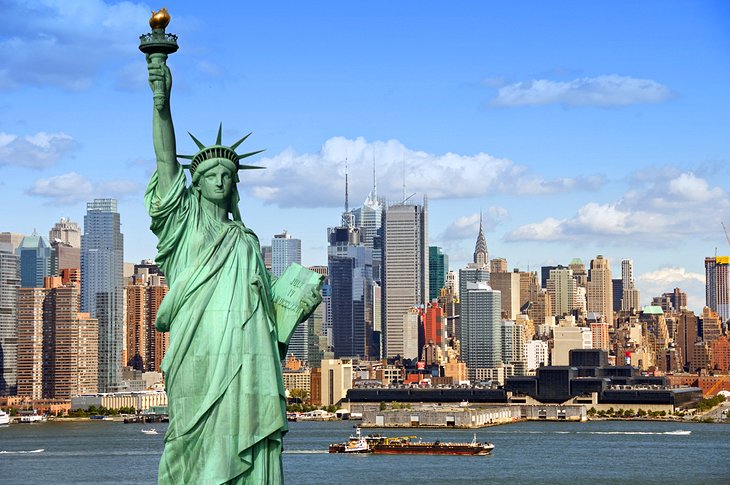 Most Visited Places in America Statue of Liberty with the New York City skyline in the background on a clear day.