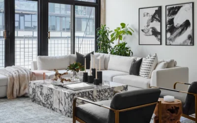 Top 10 Modern Interior Design Trends for 2025 Modern living room featuring white sectional sofa, black armchairs, marble coffee table, indoor plants, and abstract wall art