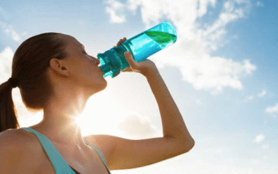 Why Hydration is Key to Better Health Better Health A woman drinking water from a bottle under a sunny sky, symbolizing hydration and healthy lifestyle
