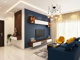 Top 10 Home Improvement Ideas That You Can Do Yourself Modern living room interior with stylish TV unit, blue feature wall, and bright yellow accent chairs