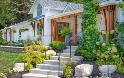 Landscape Design’s Impact on Property Value and Outdoor Living Experience A beautiful modern farmhouse featuring lush greenery and wooden design elements.