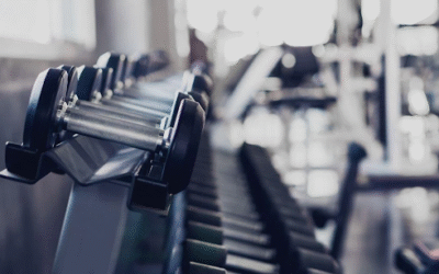 Best Exercises for Athletes – Speed Strength and Stamina The Real Formula Close-up of dumbbells neatly arranged in a modern gym.