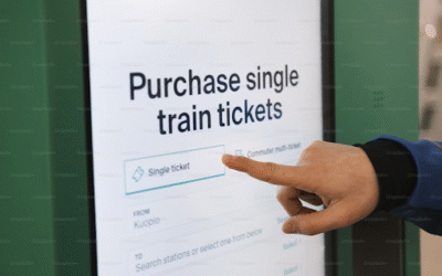 Train Ticket Booking – A Complete Guide for Easy and Smart Travel Hand pointing at a digital kiosk screen to purchase a single train ticket online
