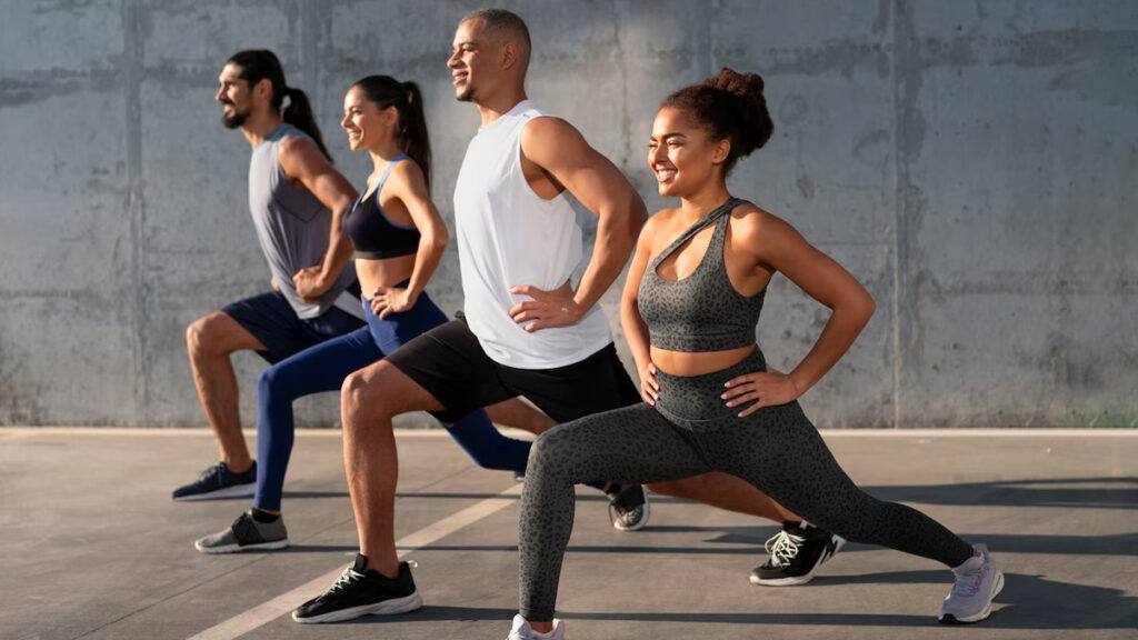 Group of people performing lunges outdoors, demonstrating effective exercise techniques for strength and fitness